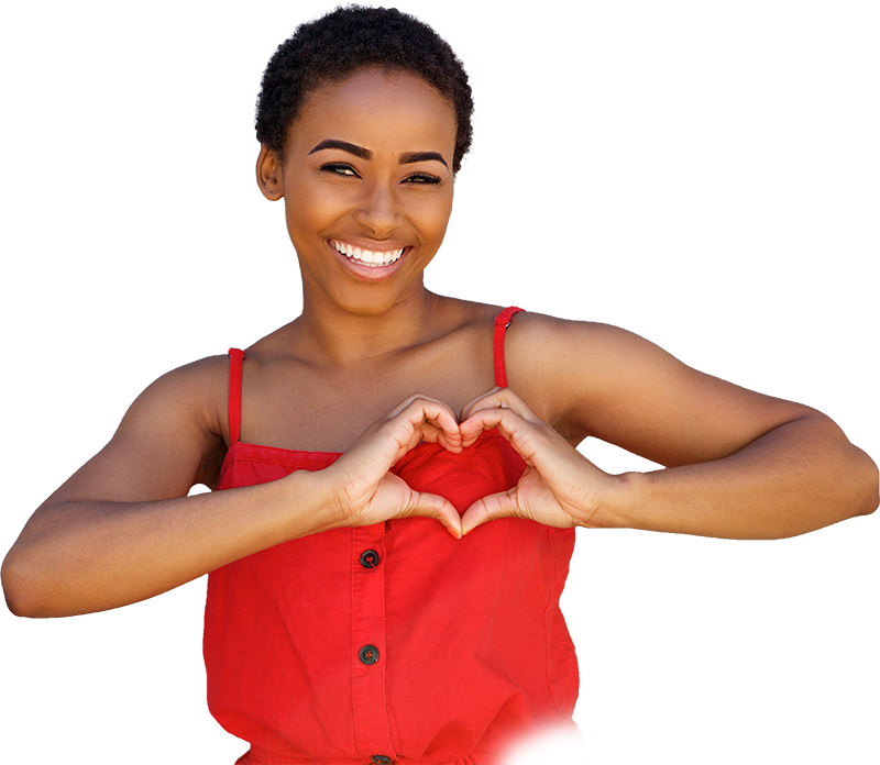 Woman smiling and holding her hands into a heart shape.